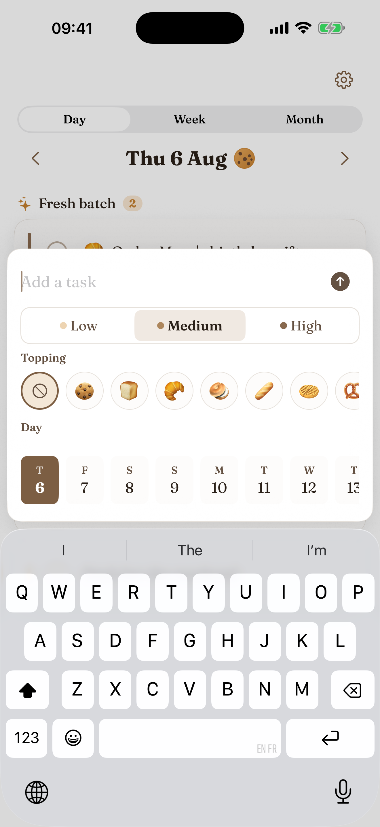 Cookie Do's Edit task sheet on a white screen with Fraunces serif headings: a task title, notes, a Low / Medium / High urgency picker, a day, and a row of cookie, croissant, bread and cake topping emoji to give the task a little icon. Cancel and Save sit in soft brown at the top.
